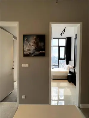 a living room with a painting on the wall at KL Suites Axon Residence - Wi-Fi 500Mbph in Kuala Lumpur