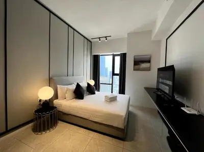 a bedroom with a bed and a television in it at KL Suites Axon Residence - Wi-Fi 500Mbph in Kuala Lumpur