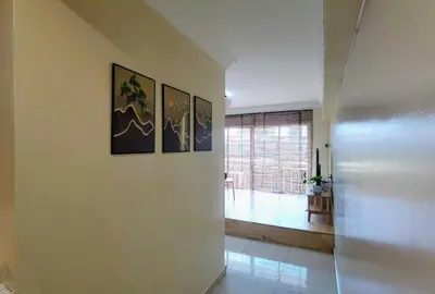 a hallway with three pictures on the wall in a house at Tatami MUJI Relax 5p City center Staycation MRT in Kuala Lumpur