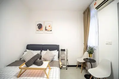 a bedroom with a bed with a table and chairs at Neu Suites By Cozy Unit L20RB near KLCC & Jelatek LRT in Kuala Lumpur