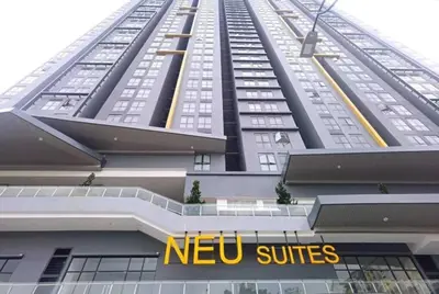 a tall building with a new suites sign in front of it at Neu Suites By Cozy Unit L20RB near KLCC & Jelatek LRT in Kuala Lumpur