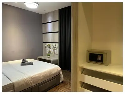 a bedroom with a bed with a teddy bear on it at Setapak Central Premium Suites in Kuala Lumpur
