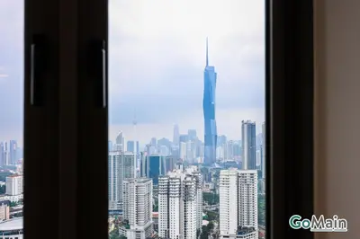 a view of a city skyline from a window at 24h Check in & SkyPool- KL Sentral Suite Riveria City Near KL Sentral KL KLCC in Kuala Lumpur