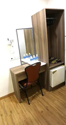 a desk with a chair and some drinks on it at ECO Hotel at BBCC in Kuala Lumpur