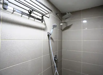 a shower with a shower head in a bathroom at ECO Hotel at BBCC in Kuala Lumpur