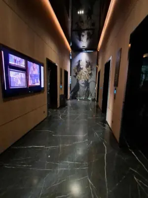 a hallway in a building with two televisions on the wall at STAR Residence KLCC City Centre in Kuala Lumpur