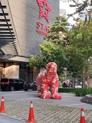 a large red teddy bear statue in front of a building at STAR Residence KLCC City Centre in Kuala Lumpur