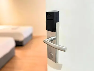 ajar door of a room with two beds at Sky Hotel Cheras Maluri in Kuala Lumpur