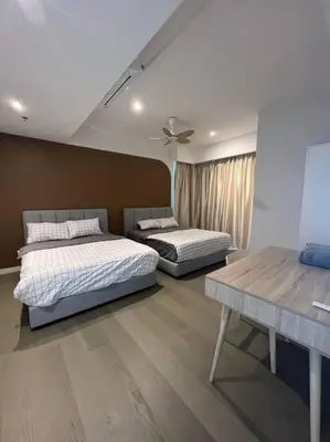 a bedroom with two beds and a table at Ooak suites Mont Kiara 163 \uc624\ud06c\uc2a4\ud14c\uc774 in Kuala Lumpur