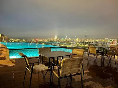 a group of tables and chairs on a balcony at Ooak suites Mont Kiara 163 \uc624\ud06c\uc2a4\ud14c\uc774 in Kuala Lumpur