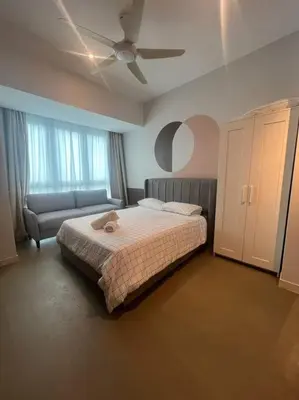 a bedroom with a bed and a ceiling fan at The Ooak Kiara 163 in Kuala Lumpur
