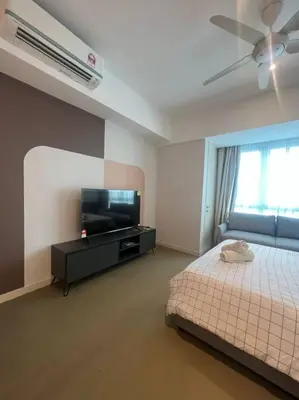 a bedroom with a bed and a flat screen tv at The Ooak Kiara 163 in Kuala Lumpur