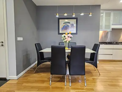a dining room with a table with chairs and a vase of flowers at St Mary Pavilion KLCC 3BR6Pax in Kuala Lumpur