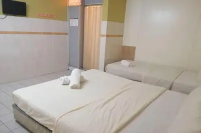 a room with two beds with stuffed animals on them at Hotel Dlima House Bukit Bintang in Kuala Lumpur