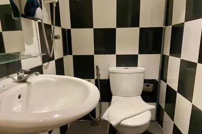 a bathroom with a sink and a toilet at Hotel Dlima House Bukit Bintang in Kuala Lumpur
