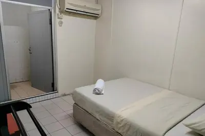 a hospital room with a bed and a shower at Hotel Dlima House Bukit Bintang in Kuala Lumpur