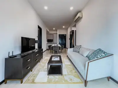 a living room with a couch and a table at Opus Residences by Wakely Kuala Lumpur in Kuala Lumpur