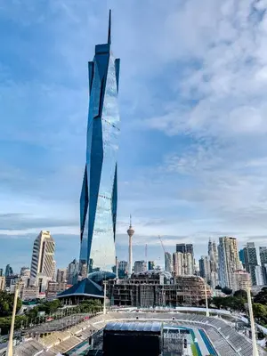a tall glass building with a city in the background at Opus Residences by Wakely Kuala Lumpur in Kuala Lumpur