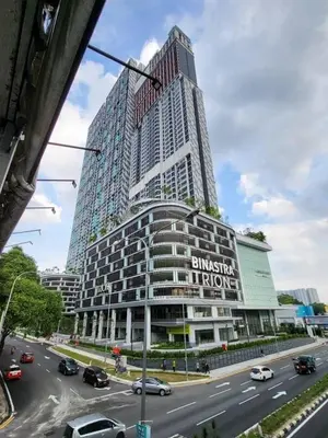 a tall building with cars on a city street at Trion Kuala Lumpur Superior room nearby mrt in Kuala Lumpur