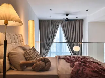 a bedroom with a teddy bear laying on a bed at Tranquil Den EkoCheras KL in Kuala Lumpur