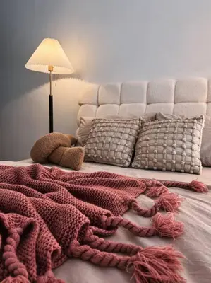a bed with a red blanket on top of it at Tranquil Den EkoCheras KL in Kuala Lumpur