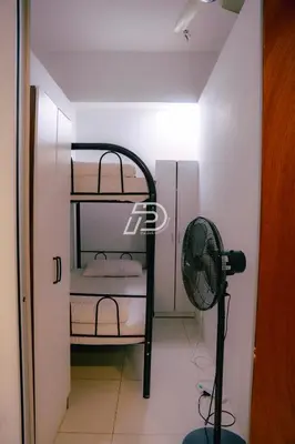 a room with two bunk beds and a fan at Infinity Pool Dorms KLCC View by Regalia in Kuala Lumpur