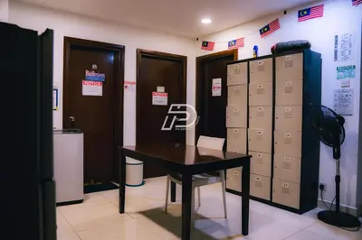 a locker room with a desk and lockers and a table at Infinity Pool Dorms KLCC View by Regalia in Kuala Lumpur