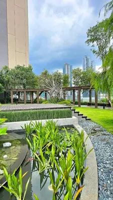 a park with a pond and benches and buildings at Cozy Axon Residence Bukit Bintang by Konoha Suites 1-3pax in Kuala Lumpur