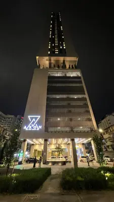 a large building with a zdaq sign on it at night at Cozy Axon Residence Bukit Bintang by Konoha Suites 1-3pax in Kuala Lumpur