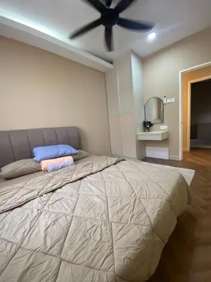a bedroom with a large bed with a ceiling fan at Best Spot in City in Kuala Lumpur