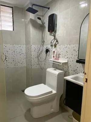 a bathroom with a white toilet and a sink at Best Spot in City in Kuala Lumpur