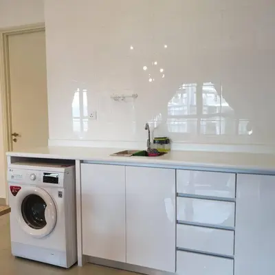 a white kitchen with a washing machine and a sink at Arte Plus Jalan Ampang, KLCC Level 35 in Kuala Lumpur