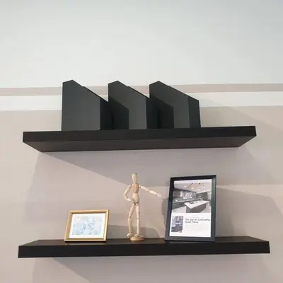 a wooden mannequin sitting on a black shelf at Arte Plus Jalan Ampang, KLCC Level 35 in Kuala Lumpur