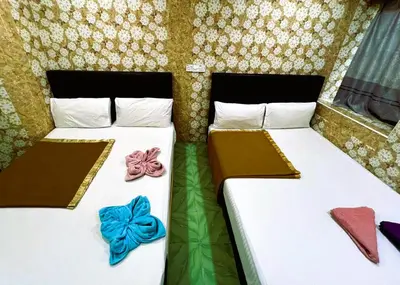 two beds in a room with bow ties on them at ARK Wave Hotel Ampang in Ampang