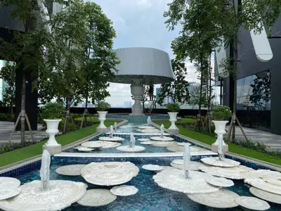 a water fountain with white vases and plates on it at Arte Mont Kiara Studio,Kuala Lumpur in Kuala Lumpur