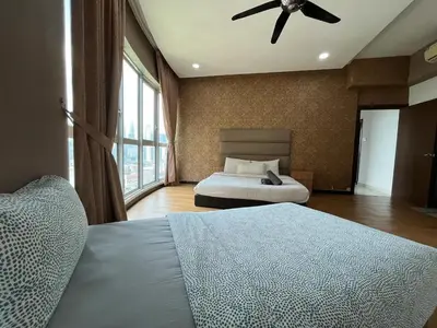 a bedroom with two beds and a ceiling fan at Nice stay by regalia in Kuala Lumpur