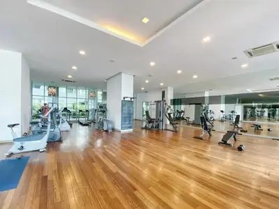 a gym with treadmills and ellipticals in a large room at Nice stay by regalia in Kuala Lumpur