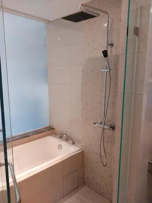 a bathroom with a bath tub and a shower at 2-Bedroom Apartment in Kuala Lumpur City Center in Kuala Lumpur