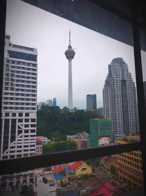 a view from a window of a city with a tower at 2-Bedroom Apartment in Kuala Lumpur City Center in Kuala Lumpur