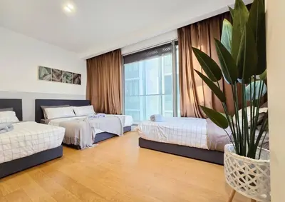 a hotel room with two beds and a potted plant at Bukit Bintang Fairlane 1412 for 1-5pax 1BR TRX Pavilion KL in Kuala Lumpur