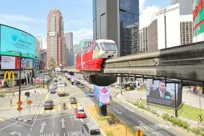 a train on a bridge over a busy city street at Bukit Bintang Fairlane 1412 for 1-5pax 1BR TRX Pavilion KL in Kuala Lumpur
