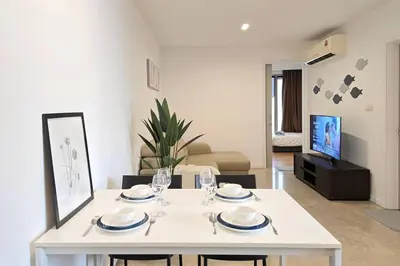 a living room with a white table and chairs at Bukit Bintang Fairlane 1412 for 1-5pax 1BR TRX Pavilion KL in Kuala Lumpur