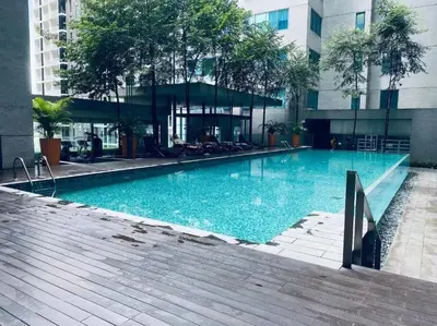 a large swimming pool in front of a building at Prime Summer Suites KLCC in Kuala Lumpur