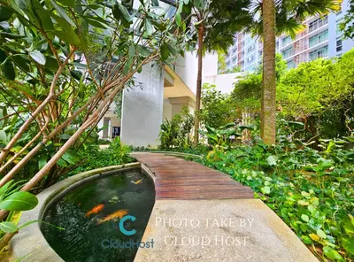 a wooden bridge over a pond in a garden at The Mews Kuala Lumpur Homestay with Bathtub 700m to KLCC by Cloud Host in Kuala Lumpur