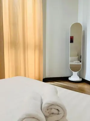 a room with a bed with a mirror and a toilet at Regalia Residence By Willow Home in Kuala Lumpur