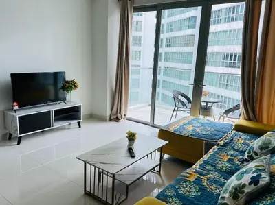 a living room with a couch and a tv at Regalia Residence By Willow Home in Kuala Lumpur