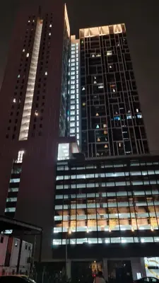 two tall buildings are lit up at night at Chambers Suites KLCC By Glory Homes in Kuala Lumpur