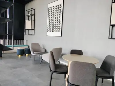 a waiting room with a table and chairs at Continew TRX Corner 2-BR, 2 Balconies City Views in Kuala Lumpur