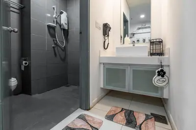 a bathroom with a sink and a shower at Twin Towers Suites - 7mins walking to KLCC in Kuala Lumpur