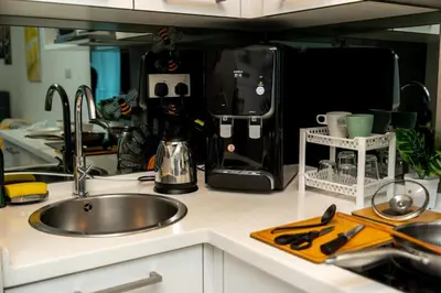 a kitchen counter with a sink and a mixer at Twin Towers Suites - 7mins walking to KLCC in Kuala Lumpur